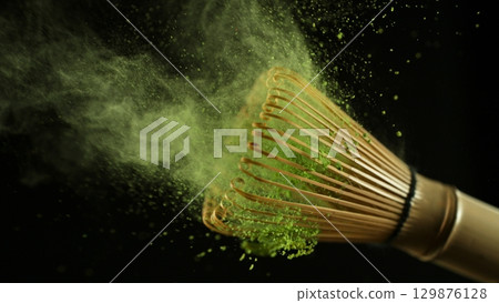 Freeze Motion Detail Shot of Sprinkling Matcha Powder on Stirrer Freeze Motion Detail Shot of Sprinkling Matcha Powder on Stirrer 129876128