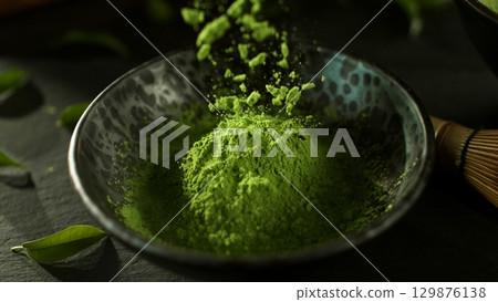 Freeze Motion Detail Shot of Sprinkling Matcha Powder 129876138