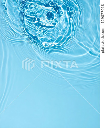 Light blue water with ripples and waves background 129877018