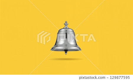 Metal bell over yellow background 129877595