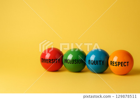 Red and orange marbles with words diversity and inclusion among other colors, symbolizing collaboration in an equitable environment 129878511