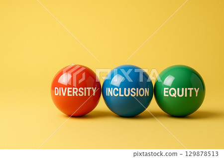 Red, green, and orange marbles on yellow background, symbolizing equality and shared responsibility in diverse representation Red, green, and orange marbles on yellow background, symbolizing equality and shared responsibility in diverse representation 129878513