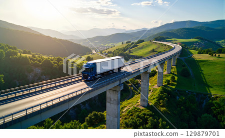 A large blue truck running on a viaduct in the mountains 129879701
