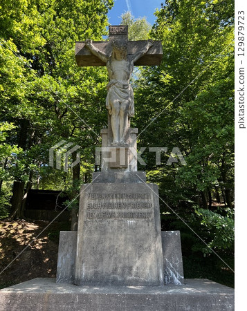 Stone cross with crucifix near the town of Riesenbeck, Germany 129879723