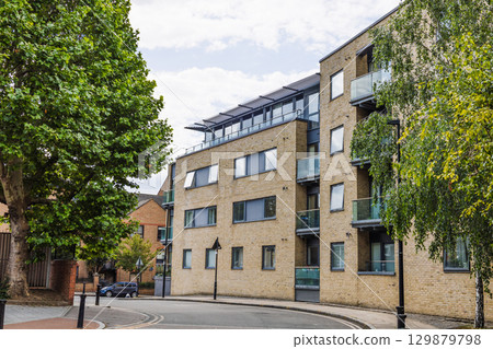 Modern brick apartment building on quiet tree lined street in Greenwich, London Modern brick apartment building on quiet tree lined street in Greenwich, London 129879798