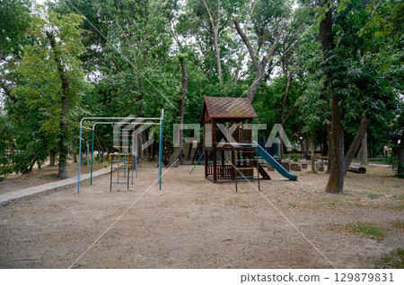 Children's playground with a view of the house and slide in the park Children's playground with a view of the house and slide in the park 129879831