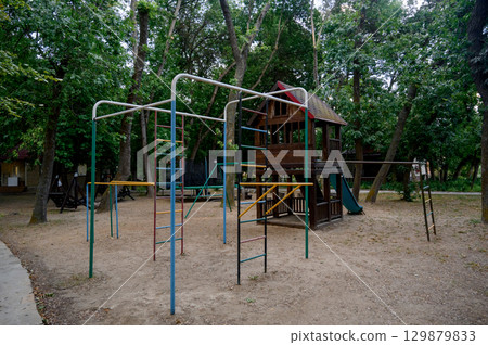 Children's playground with a view of the house and slide in the park Children's playground with a view of the house and slide in the park 129879833