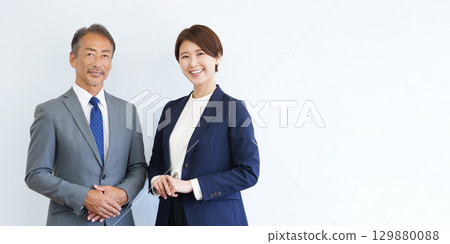 Businessmen and women looking at camera Businessmen and women looking at camera 129880088