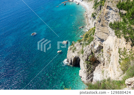 natural cave and cliffs on the coast of Montenegro, Europe. Calypso beach natural cave and cliffs on the coast of Montenegro, Europe. Calypso beach 129880424