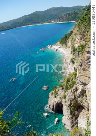 natural cave and cliffs on the coast of Montenegro, Europe. Calypso beach 129880442