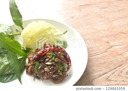 spicy fried chop pork salad Thai northern style with fresh vegetable on plate 129881059