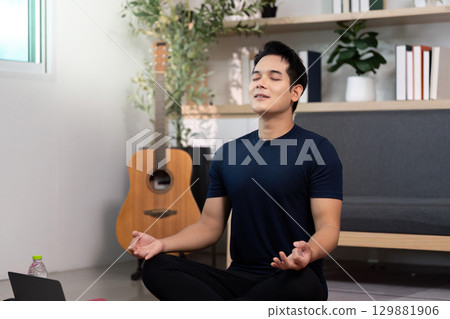 Mindfulness and Wellness. Man meditating with guitar in background. Mindfulness and Wellness. Man meditating with guitar in background. 129881906