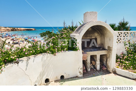 Weathered outdoor barbecue and beach view 129883330