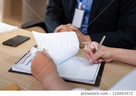 Insurance Agent Explaining Policy Terms to Client. Business meeting focused on clarity. 129883472