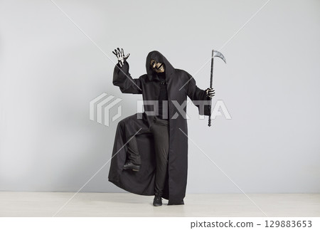Grim Reaper Dancing With Scythe At A Halloween Party On A Grey Background 129883653
