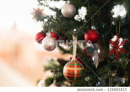 Christmas tree decorated with red and silver ornaments Christmas tree decorated with red and silver ornaments 129883815