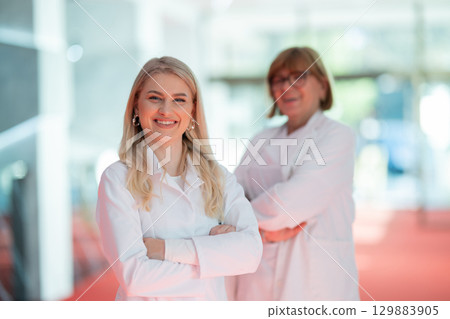 Portrait Confident young doctor with senior colleague in hospital 129883905