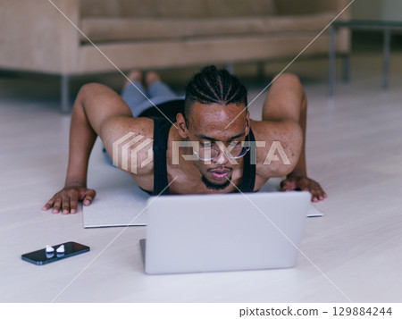 Home Push Up Workout with Laptop Guidance 129884244