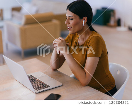 Smiling Woman on Video Call at Laptop Smiling Woman on Video Call at Laptop 129884251