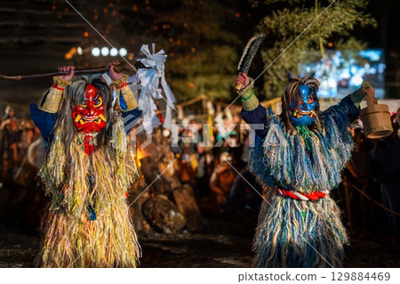 Red and blue Namahage pose with arms raised Red and blue Namahage pose with arms raised 129884469