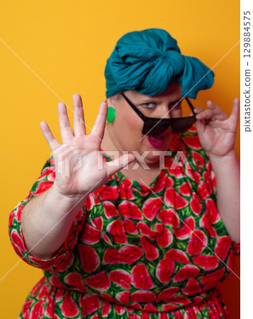Cool plus size woman crossing arms with sunglasses Cool plus size woman crossing arms with sunglasses 129884575