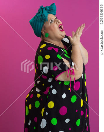 Funny woman raising hands with shocked expression Funny woman raising hands with shocked expression 129884656