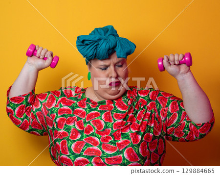Funny plus size woman lifting dumbbells in watermelon dress Funny plus size woman lifting dumbbells in watermelon dress 129884665