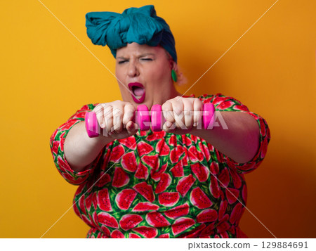 Funny plus size woman lifting dumbbells in watermelon dress Funny plus size woman lifting dumbbells in watermelon dress 129884691