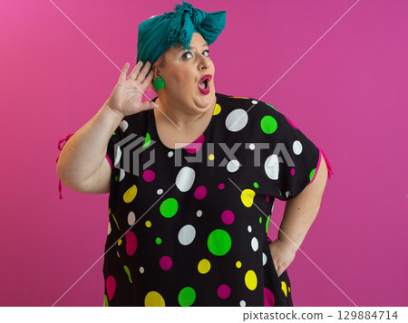Funny woman raising hands with shocked expression 129884714