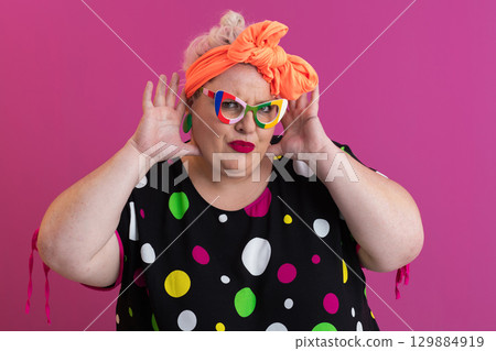 Excited woman with hands raised in surprise Excited woman with hands raised in surprise 129884919