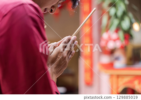 Traditional Chinese New Year Celebration with Incense and Festive Decorations in a Vibrant Cultural Setting Traditional Chinese New Year Celebration with Incense and Festive Decorations in a Vibrant Cultural Setting 129885019