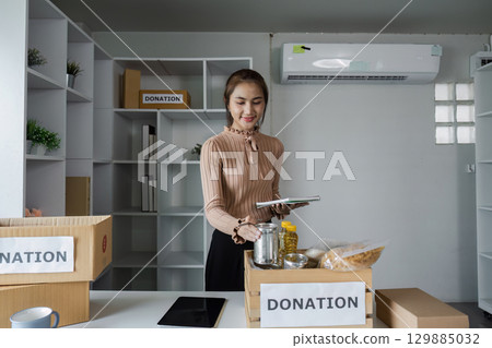 Volunteers Organizing Donations at Food Bank Center for Community Support and Charity Work Volunteers Organizing Donations at Food Bank Center for Community Support and Charity Work 129885032