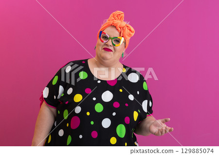 Shrugging woman in colorful dress with confused look Shrugging woman in colorful dress with confused look 129885074