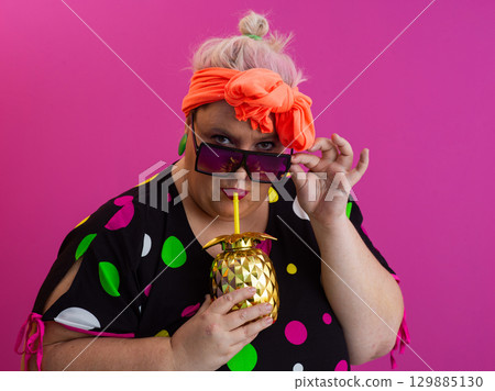 Stylish Woman with Pineapple Drink Against Pink Background Stylish Woman with Pineapple Drink Against Pink Background 129885130