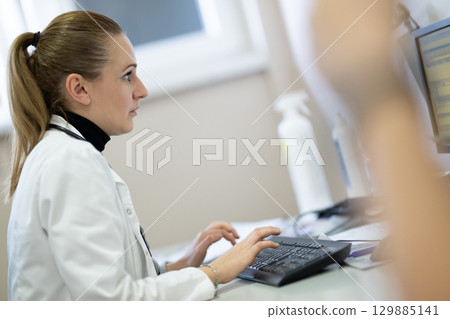 Female doctor working on computer in clinic Female doctor working on computer in clinic 129885141