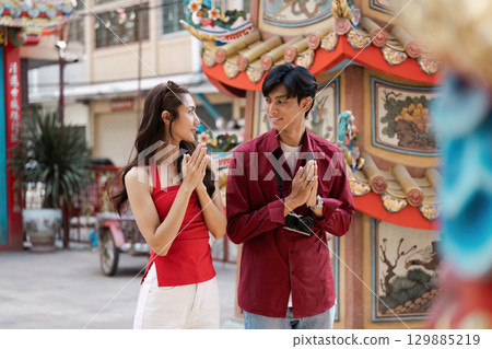 Joyful Celebration of Chinese New Year with Traditional Decorations and Festive Atmosphere in a Vibrant Urban Setting 129885219