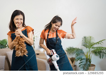 Joyful Housekeepers Engaged in Fun and Efficient Home Cleaning with Modern Tools and Techniques Joyful Housekeepers Engaged in Fun and Efficient Home Cleaning with Modern Tools and Techniques 129885293