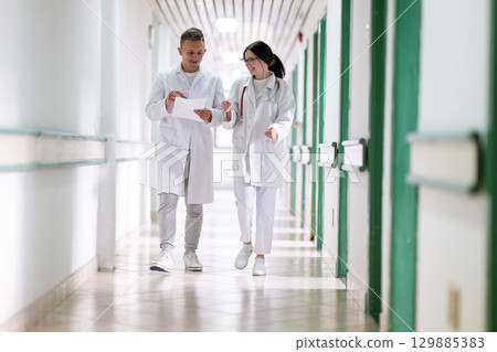 Doctors Walking in Hospital Hallway Doctors Walking in Hospital Hallway 129885383