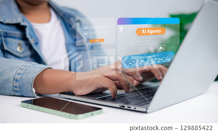Artificial intelligence, innovation, futuristic technology, digital assistant, business and data processing concept. Person typing on laptop with holographic AI agents interface. Artificial intelligence, innovation, futuristic technology, digital assistant, business and data processing concept. Person typing on laptop with holographic AI agents interface. 129885422