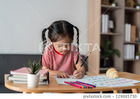 Child Learning with Parent at Home - Educational and Family Bonding Concept in a Cozy Environment Child Learning with Parent at Home - Educational and Family Bonding Concept in a Cozy Environment 129885730