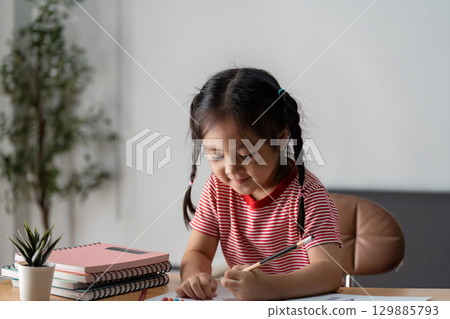 Child Learning with Parent at Home - Educational and Family Bonding Concept in a Cozy Environment 129885793