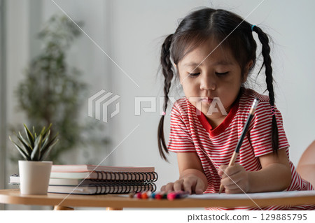 Parent and Child Engaged in Learning Activities at Home, Fostering Education and Bonding 129885795