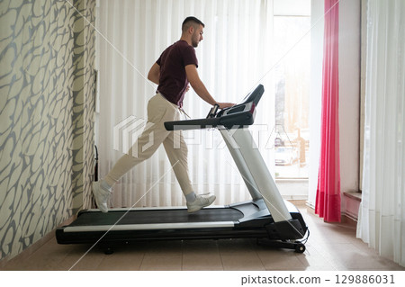 Running Therapy Indoors on Treadmill.Man running indoors on treadmill as part of a physical recovery program. Running Therapy Indoors on Treadmill.Man running indoors on treadmill as part of a physical recovery program. 129886031