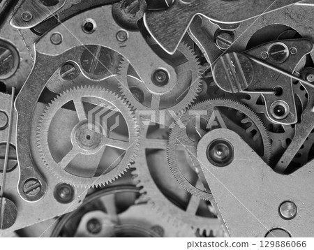 Concept Teamwork or idea Technology. Gears and cogs in clockwork. Macro. Black and white Concept Teamwork or idea Technology. Gears and cogs in clockwork. Macro. Black and white 129886066