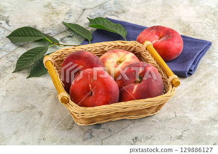 Ripe sweet and juicy Flat peach 129886127
