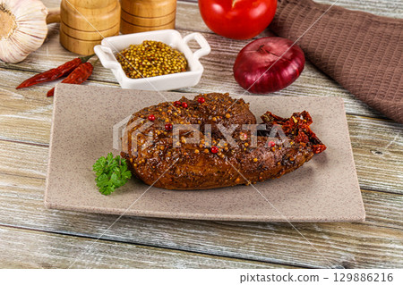 Baked pork tenderloin with mustard 129886216