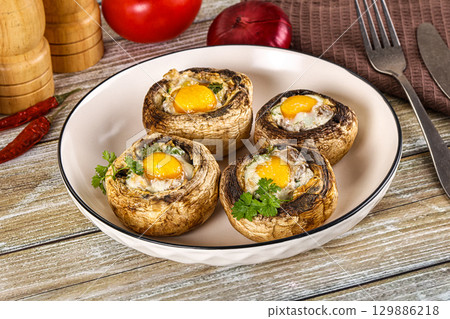 Baked champignon with quail egg Baked champignon with quail egg 129886218