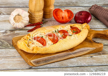 Turkish Pide with cheese and tomato 129886219
