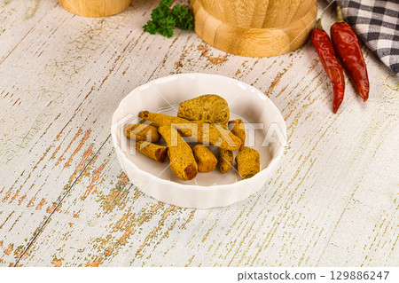 Raw dry Tumeric roots heap Raw dry Tumeric roots heap 129886247