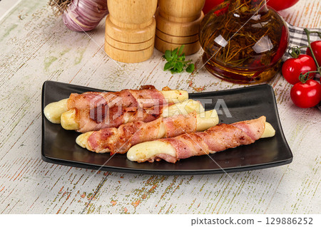 Hot mozzarella sticks with bacon 129886252